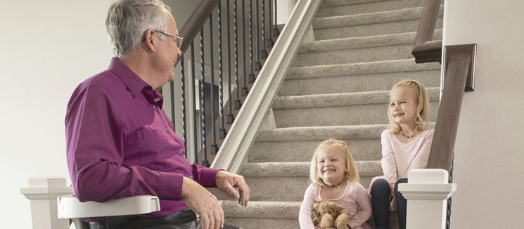 Senior using Elan stair lift